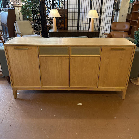 Wooden sideboard in a room with chairs and lamps