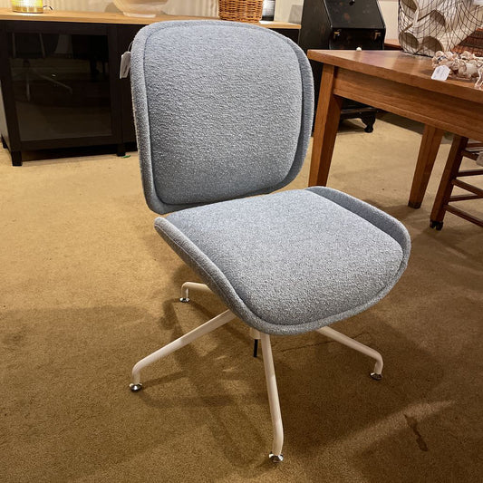 Gray office chair with white wheels in an indoor setting