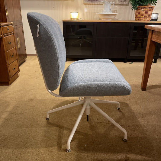 Gray office chair with white base in an office setting