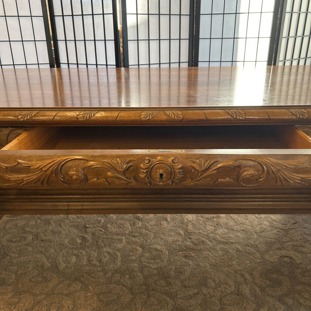 Wooden cabinet with intricate carvings on a textured surface
