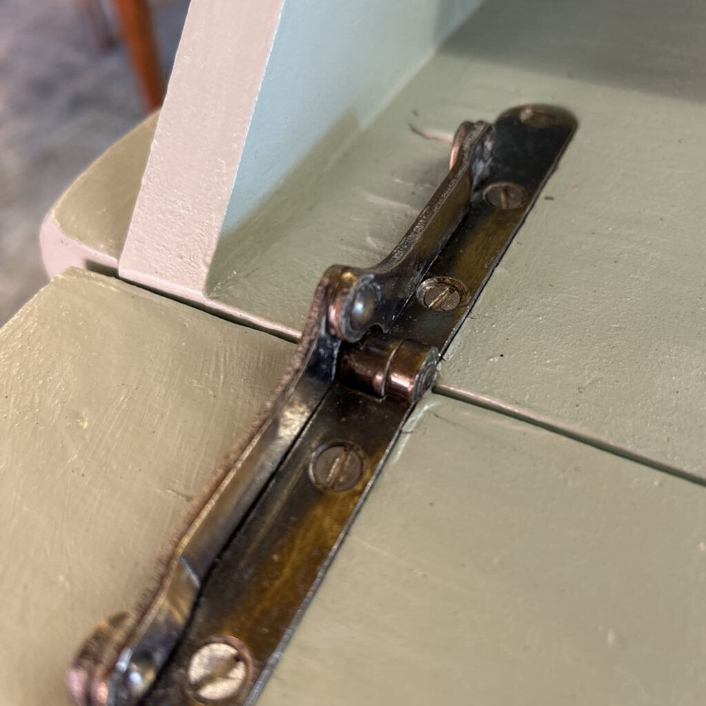 Close-up of a metal hinge on a wooden surface