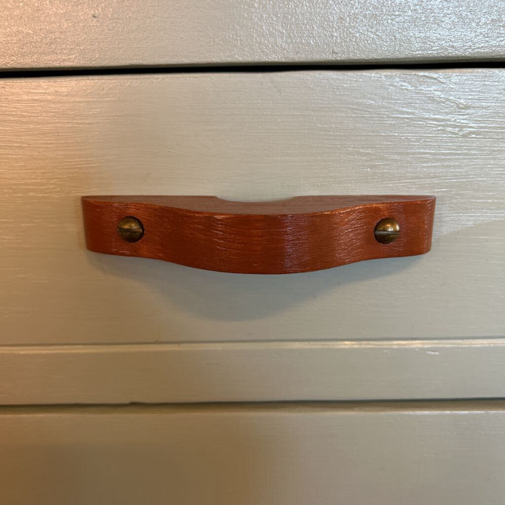 Wooden handle on a light-colored wooden surface