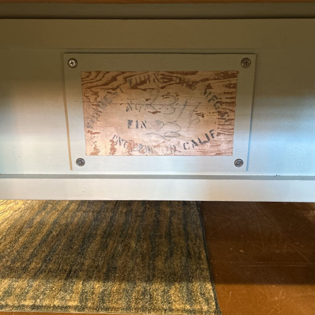 Metal plaque with engraved text on a wooden surface