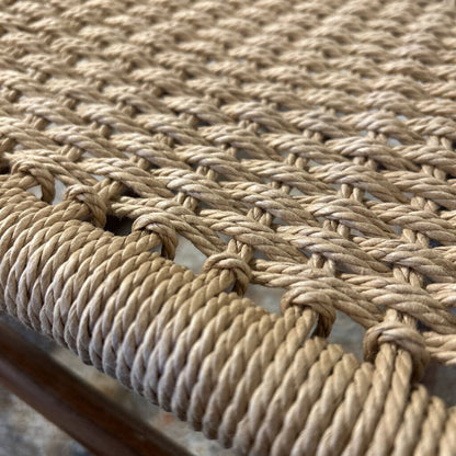 Close-up of a woven natural fiber mat with braided pattern