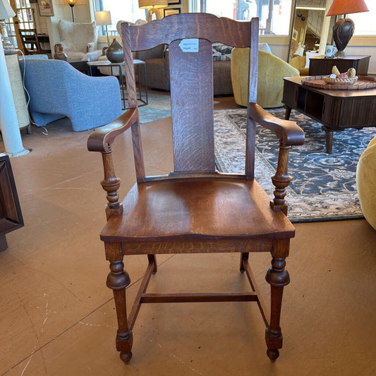 Wooden chair with armrests in a furniture store setting