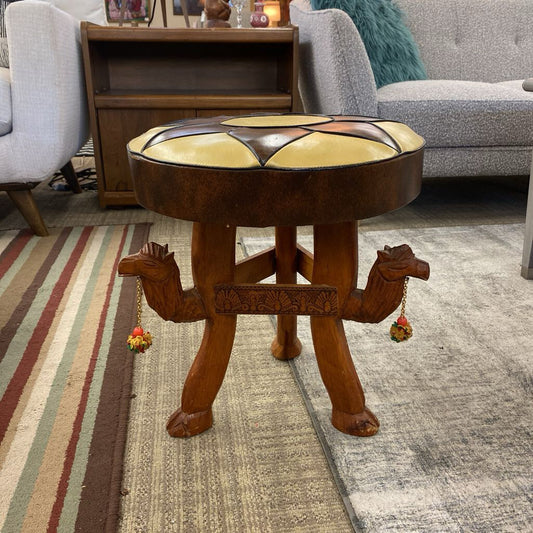 Wooden stool with animal legs in a living room setting