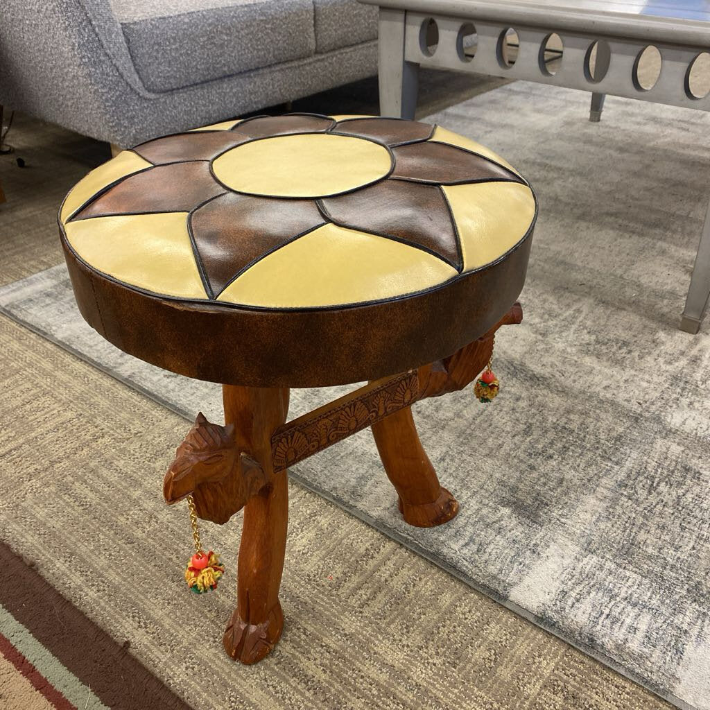 Wooden stool with decorative top in a living room setting