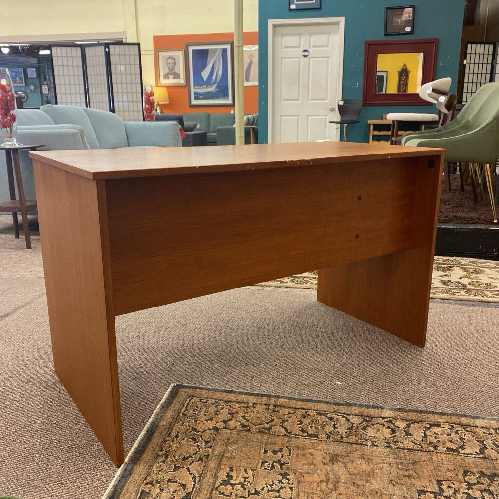Wooden desk in a room with chairs and decor