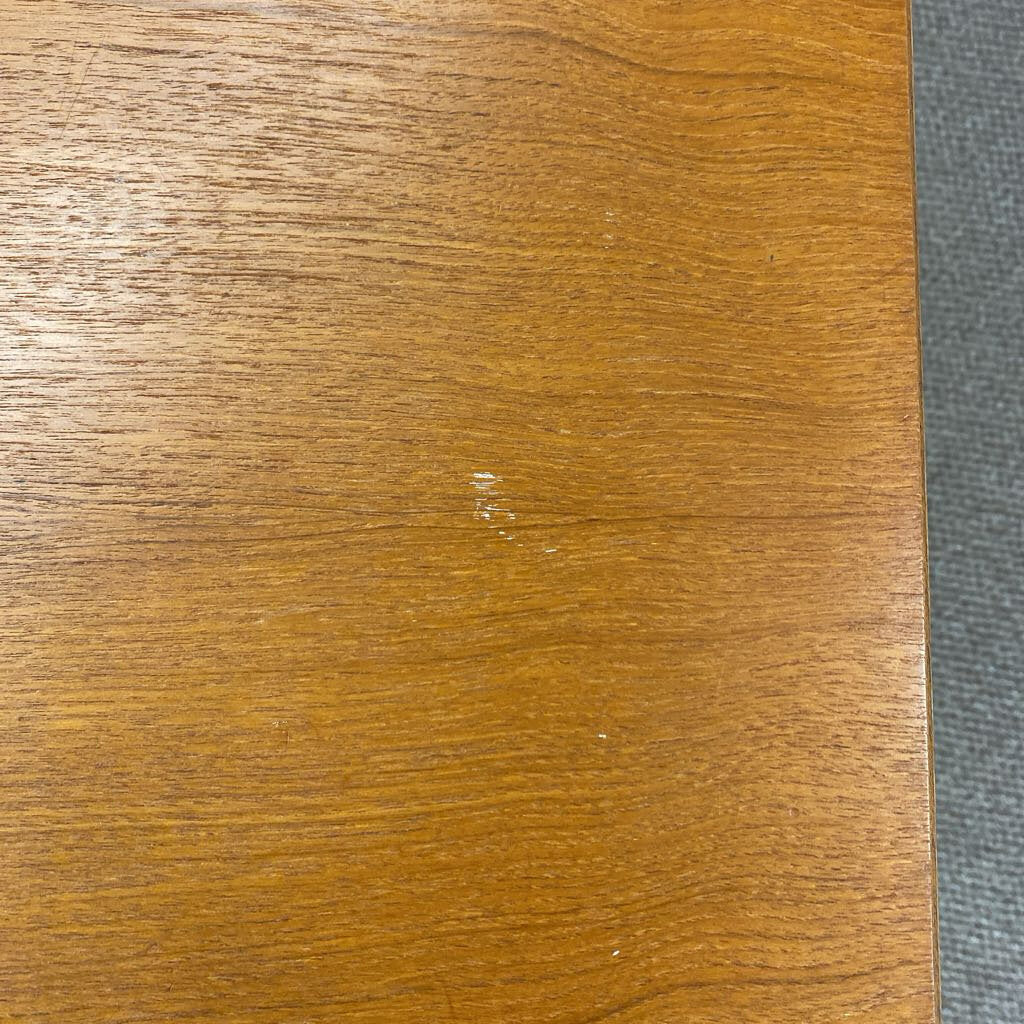 Close-up of a wooden surface with a visible scratch.