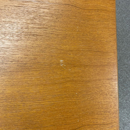 Close-up of a wooden surface with a visible scratch.