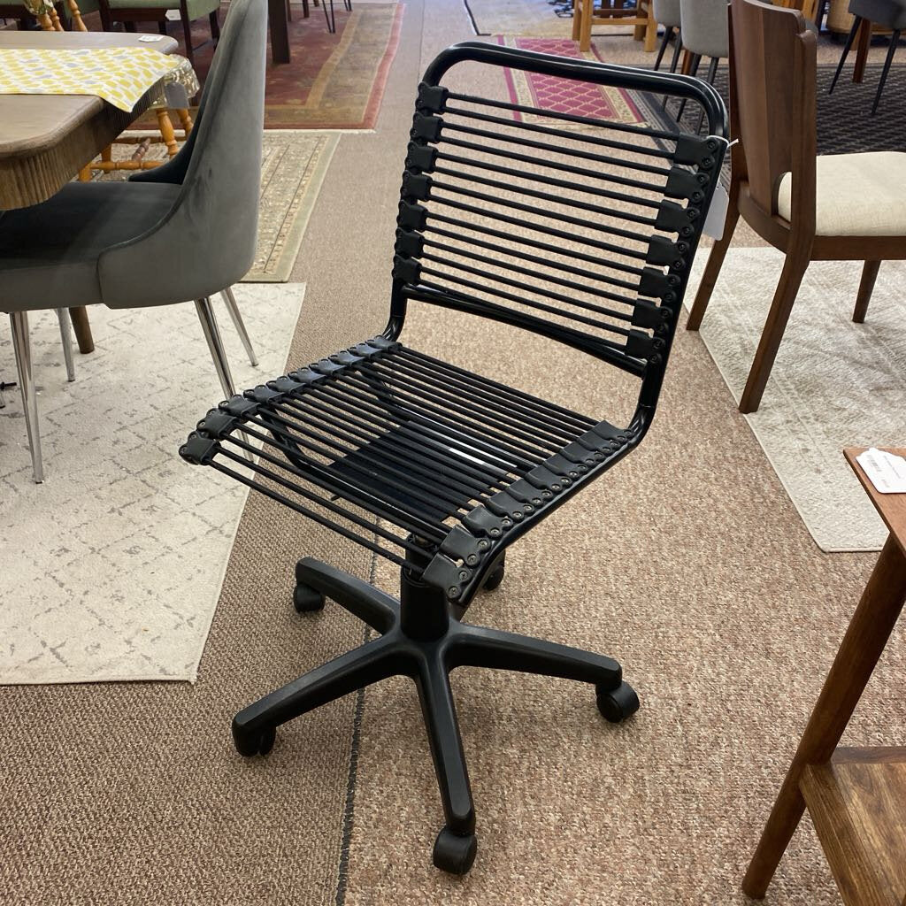 Black wire office chair in a room with tables and chairs