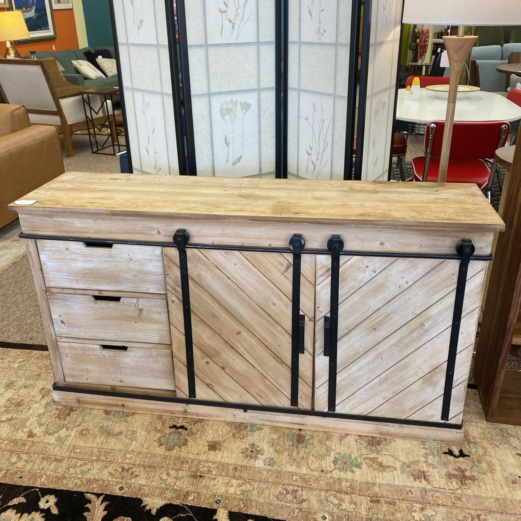 Wooden console table with sliding door in a showroom setting