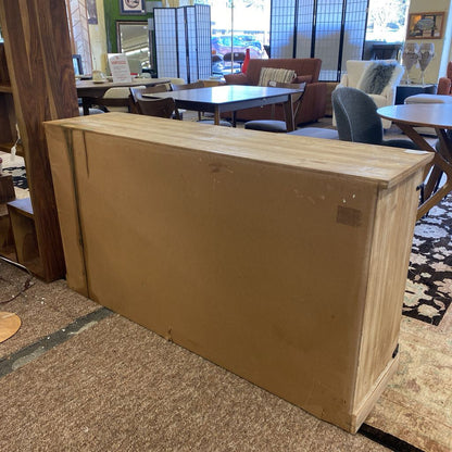 Large cardboard box on a carpeted floor in a room with furniture and decor.