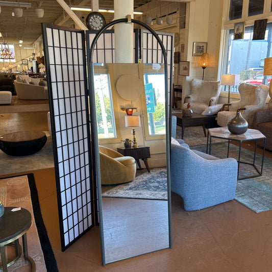 Full-length mirror with decorative screen in a room with furniture and decor.