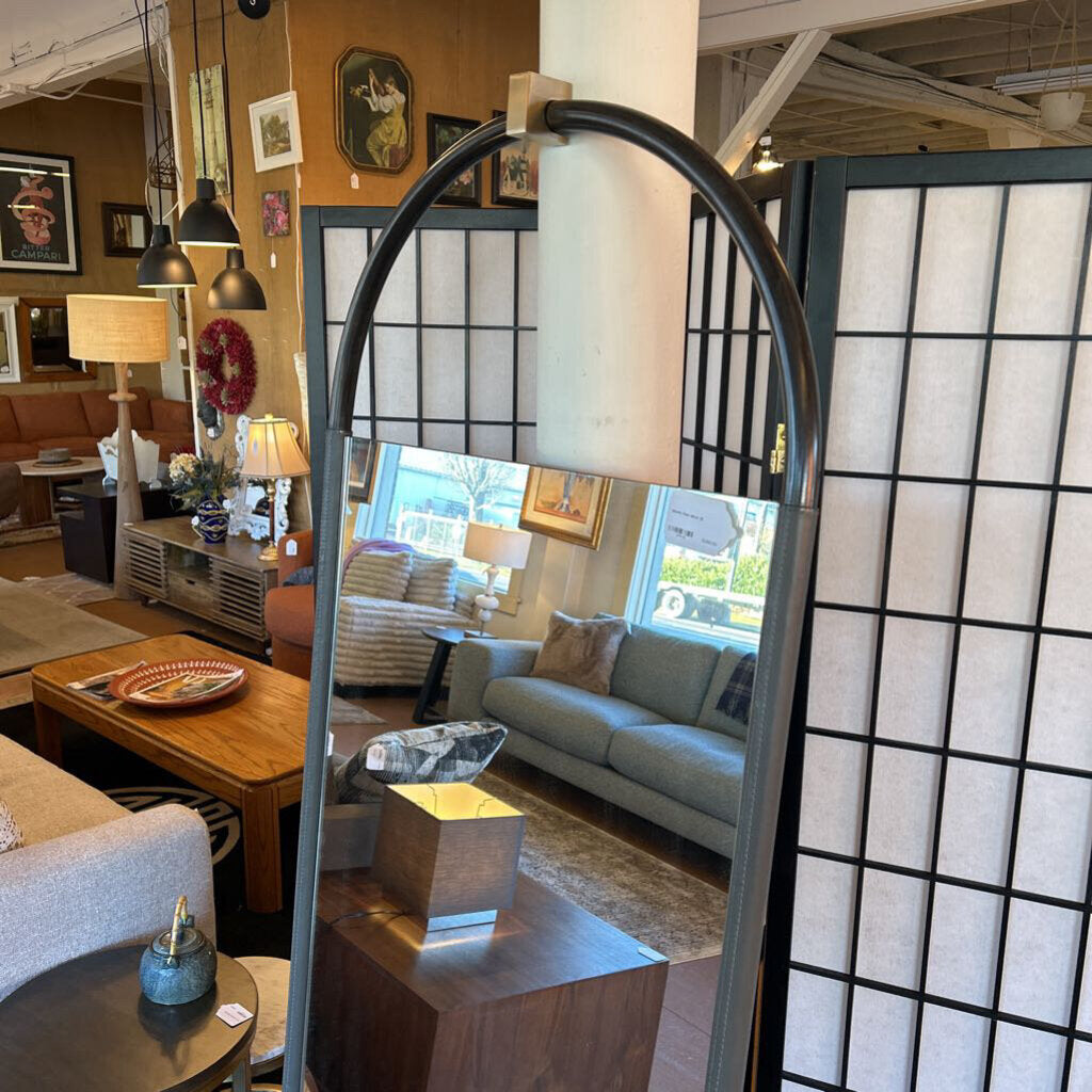 Living room with furniture and decor, including a lamp and a screen