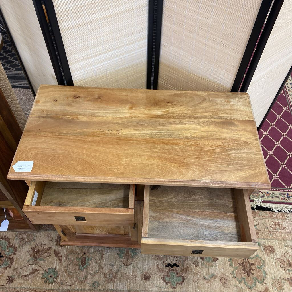 Wooden desk with a drawer on a patterned rug