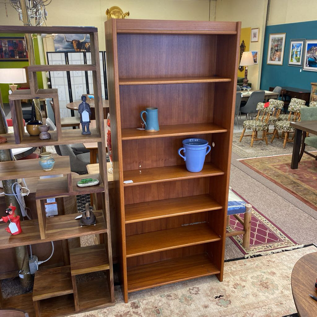 Wooden bookshelf with decorative items in a room setting