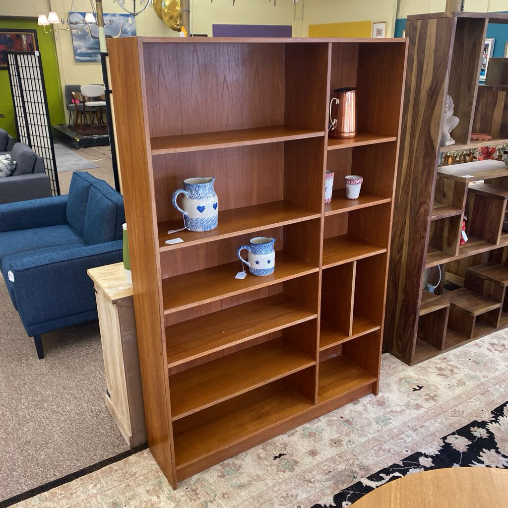 Wooden bookshelf with decorative items in a room setting