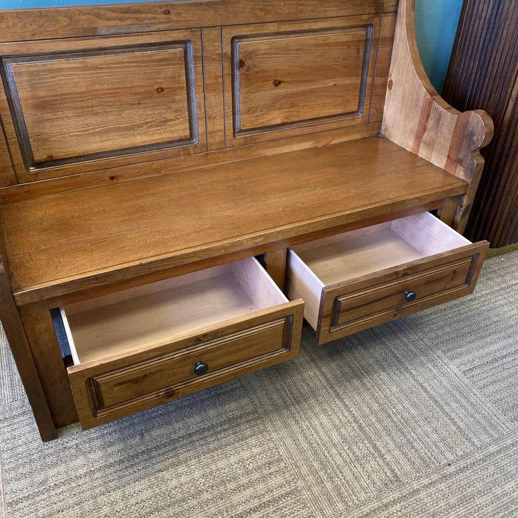 Wooden bench with storage drawers on a carpeted floor