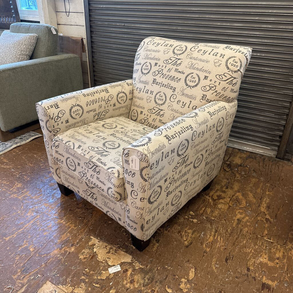 Patterned armchair on a wooden floor with a metallic shutter in the background