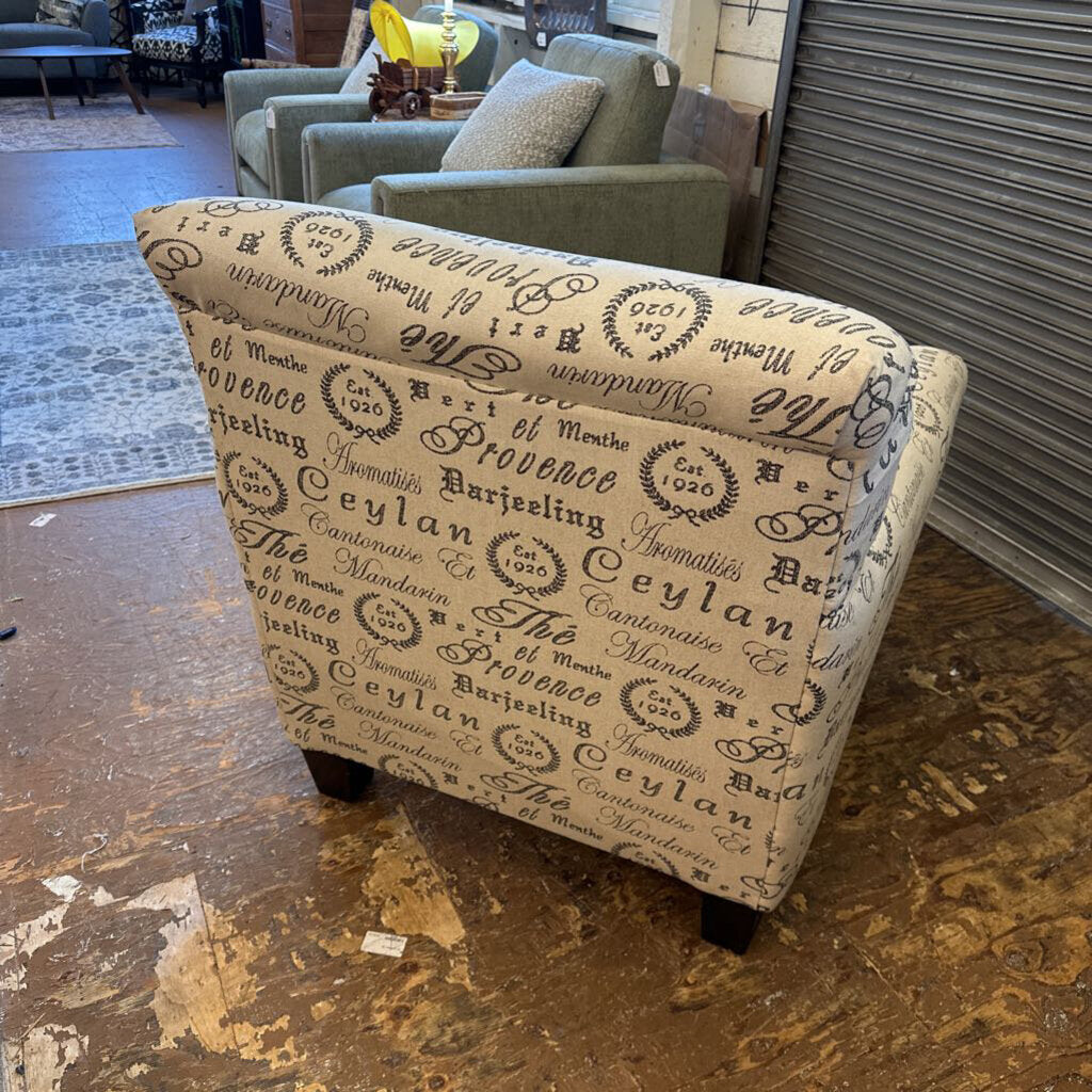 Patterned ottoman in a room with furniture and decor.