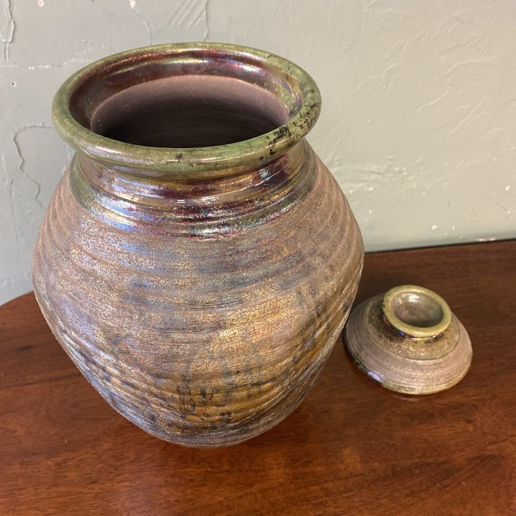 Pottery vase with a textured surface on a wooden surface