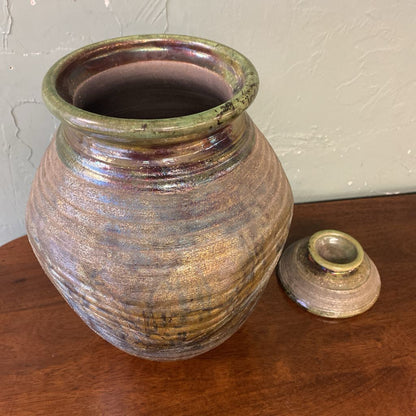 Pottery vase with a textured surface on a wooden surface