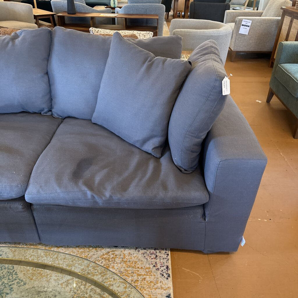 Gray sectional sofa with cushions in a store setting