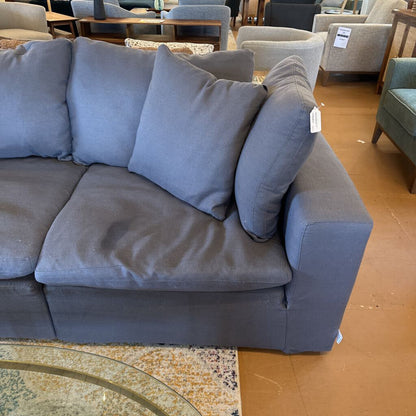 Gray sectional sofa with cushions in a store setting