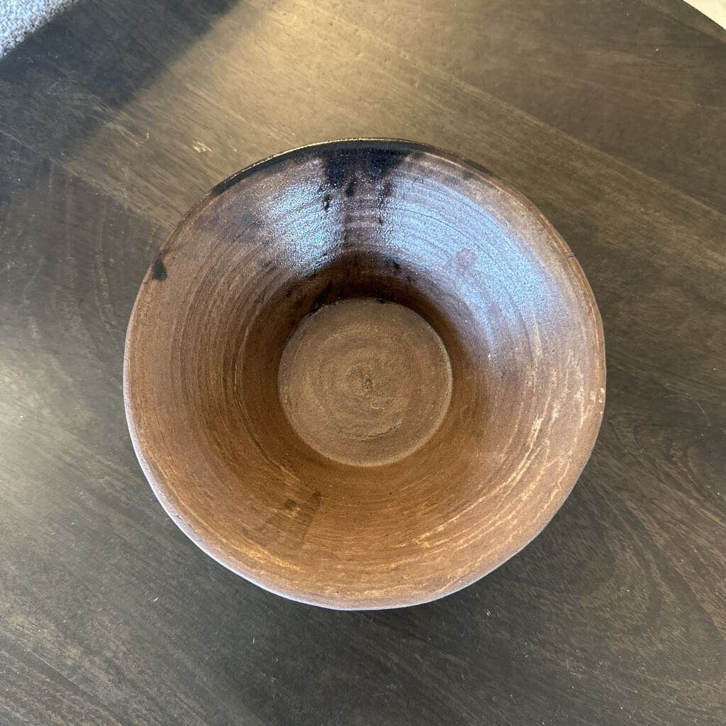 Wooden bowl on a dark wooden surface