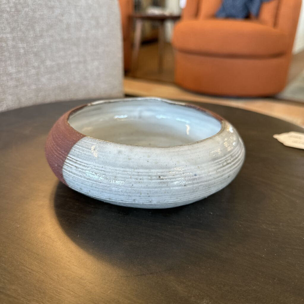 Ceramic bowl with textured design on a dark surface