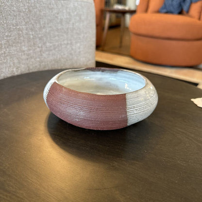 Ceramic bowl with two-tone design on a wooden table