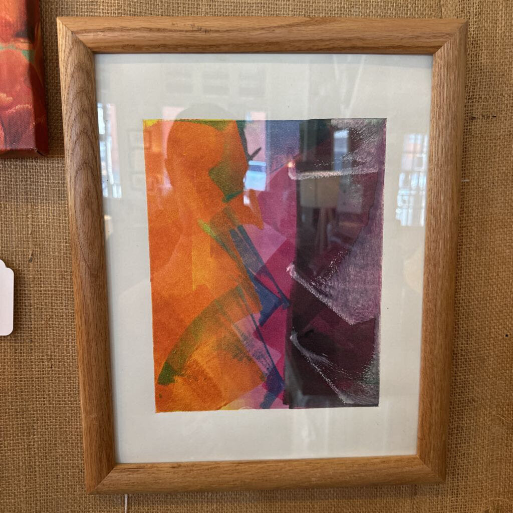 Framed abstract artwork with a wooden frame on a textured brown background