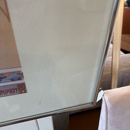 Partial view of a whiteboard with a marker on a wooden surface