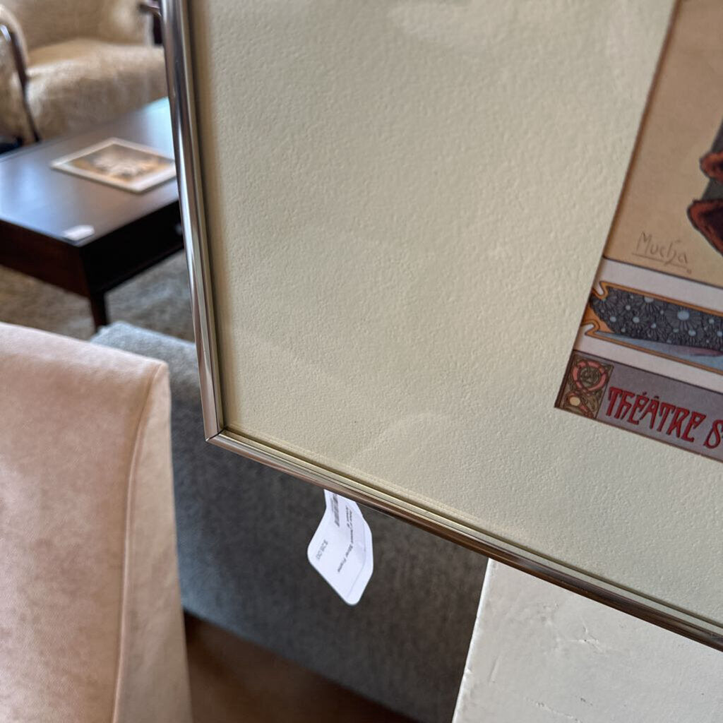 Framed artwork with a visible price tag on a wall in a room setting.