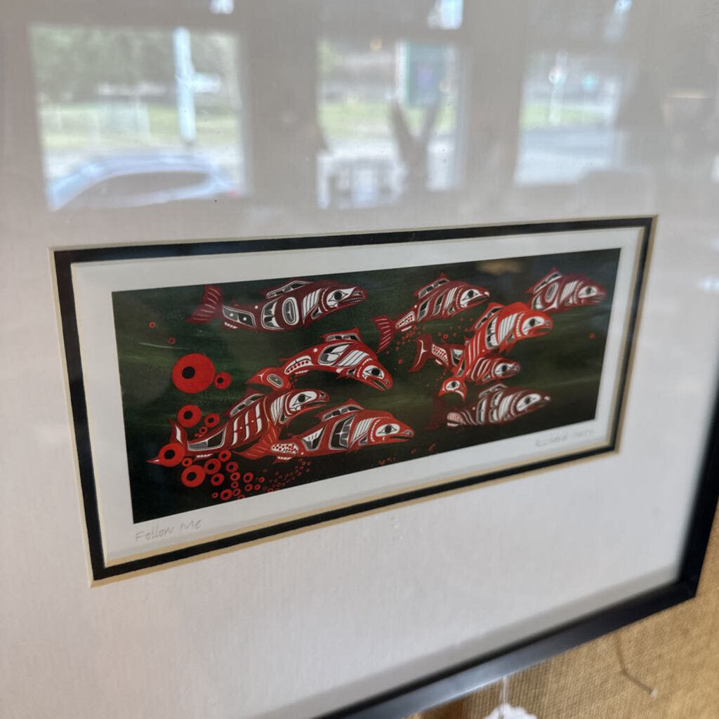 Framed artwork of red fish on a black background