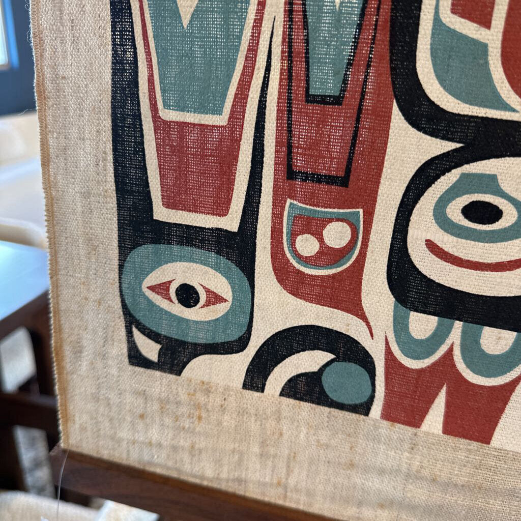 Textile with abstract design featuring red, blue, and black on a beige background.