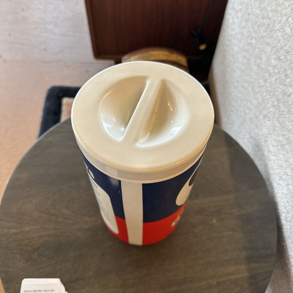 Coffee cup with a lid on a glass table