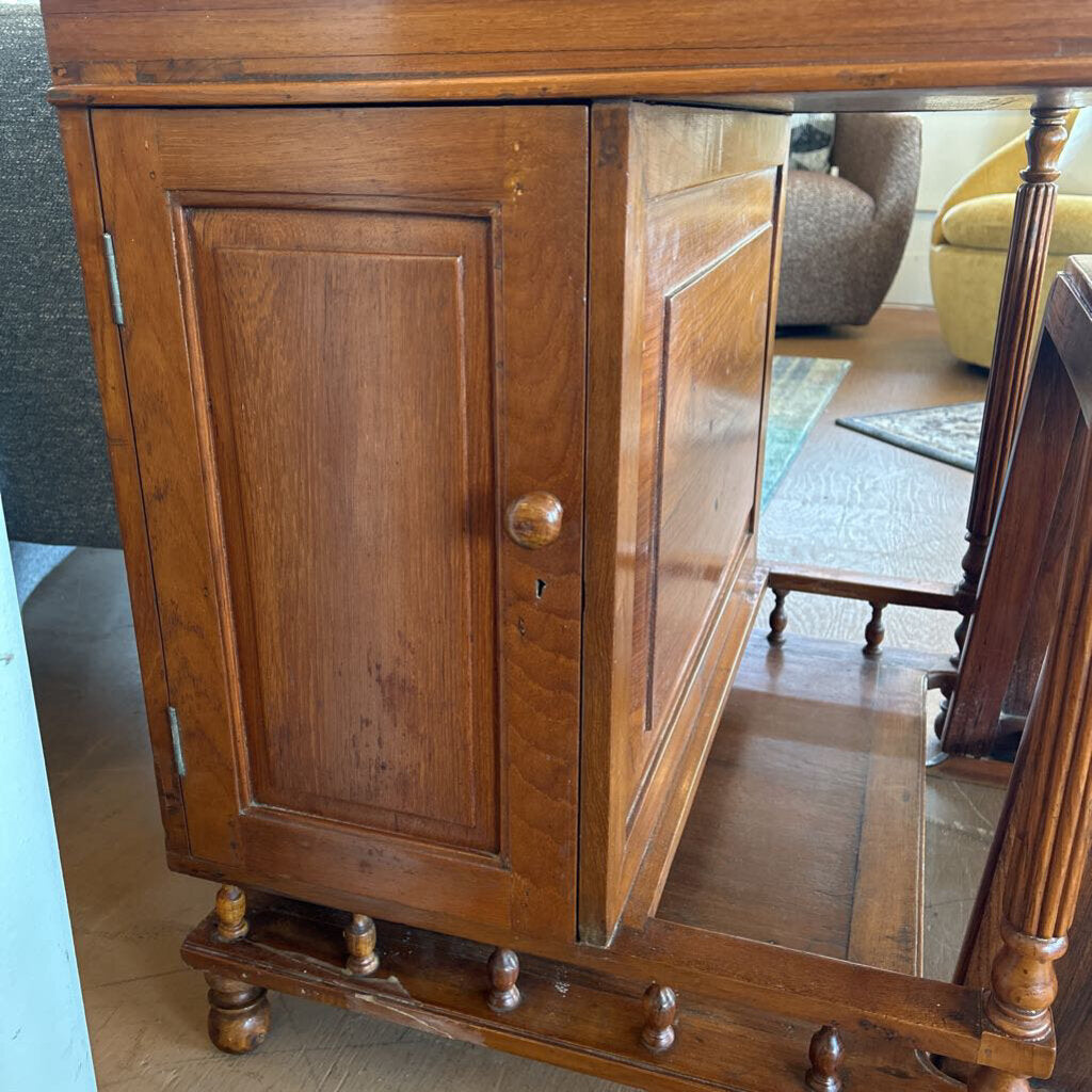 Wooden cabinet with glass door in a room setting