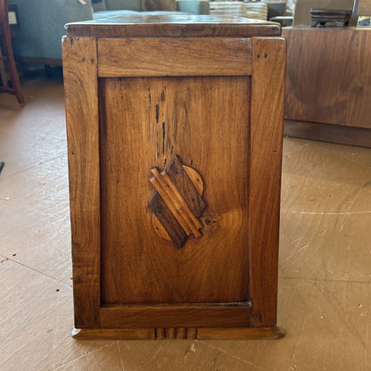 Wooden cabinet with decorative inlay on a wooden floor