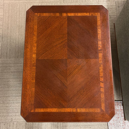Wooden cutting board with a checkered pattern on a textured surface