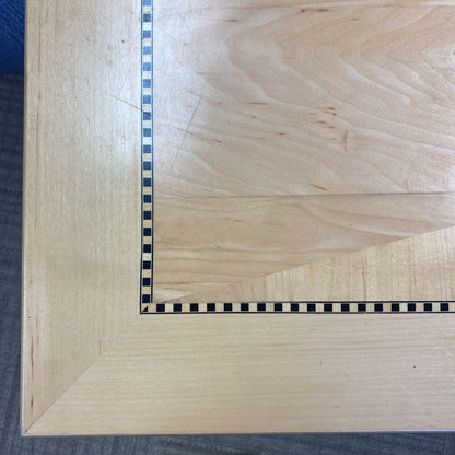 Close-up of a wooden frame corner with a blue background