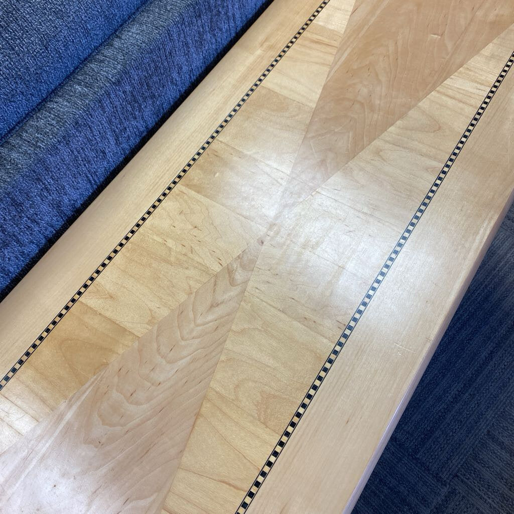 Close-up of a wooden surface with blue fabric in the background