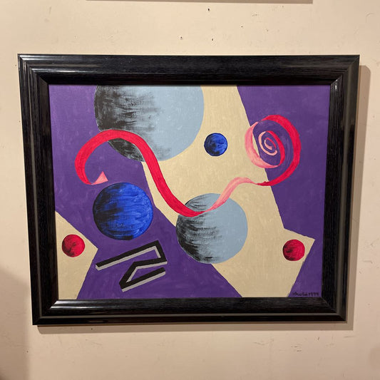 Abstract art piece with geometric shapes and vibrant colors in a black frame.