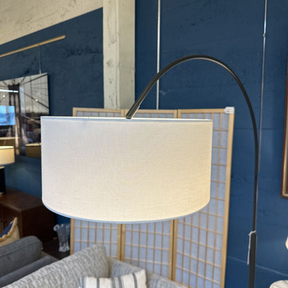 Floor lamp with a white shade in a living room setting