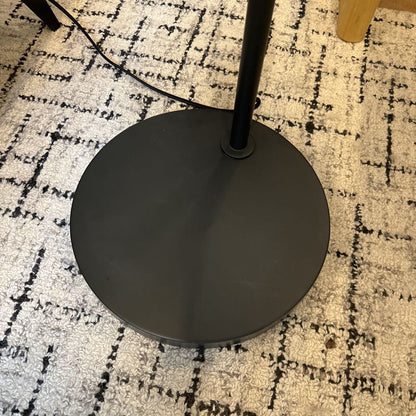 Black floor lamp base on a patterned carpet