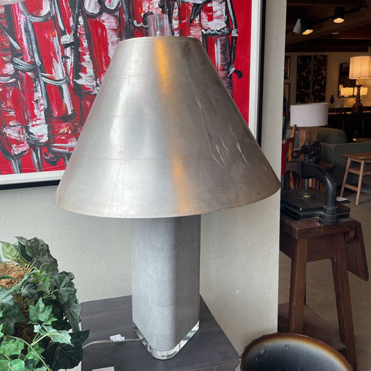 Silver table lamp with a textured shade in an indoor setting