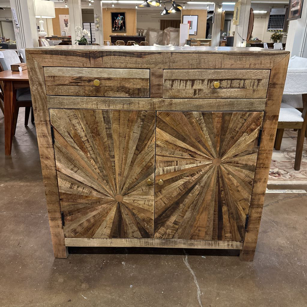 Wooden cabinet with starburst design in a showroom setting