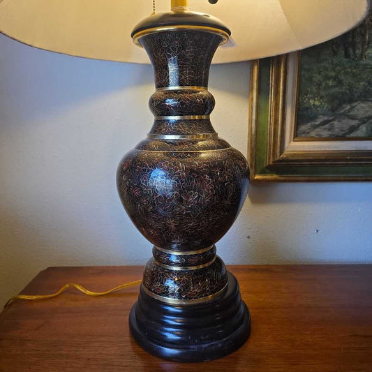 Decorative table lamp with intricate design on a wooden surface.