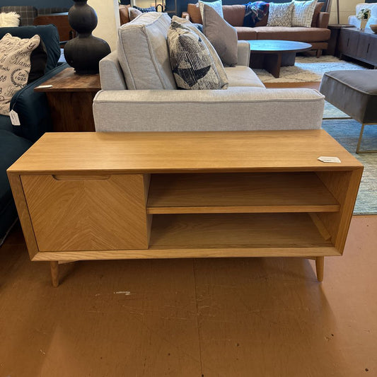 Wooden TV stand in a room with furniture and decor